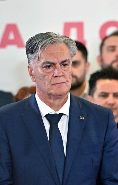 Union of Independent Social Democrats (SNSD) party candidate Sinisa Karan listens to speeches before his party members after the announcement of his victory in the election for a new Bosnian Serb president, at the nationalist party's headquarters in Banja Luka, on November 23, 2025. (Photo by ELVIS BARUKCIC / AFP)