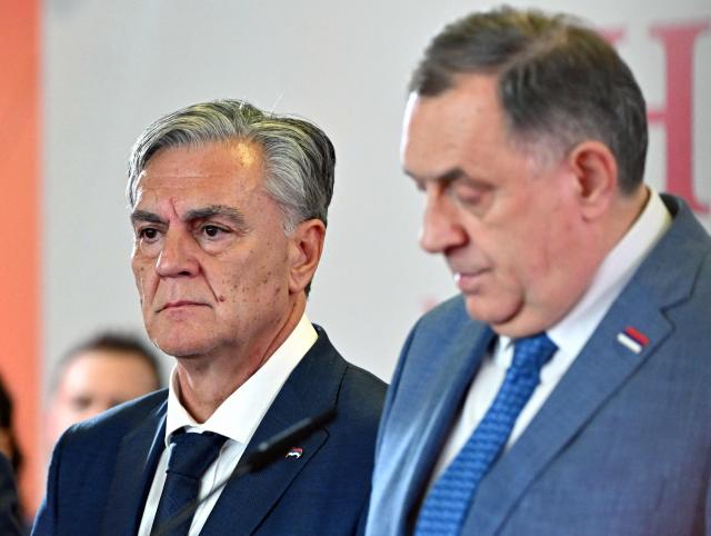 Union of Independent Social Democrats (SNSD) party candidate Sinisa Karan (L) listens to the speech of dismissed SNSD leader of the Bosnian Serb statelet Milorad Dodik (R) announcing his victory in the election for a new Bosnian Serb president, at the nationalist party's headquarters in Banja Luka, on November 23, 2025. (Photo by ELVIS BARUKCIC / AFP)