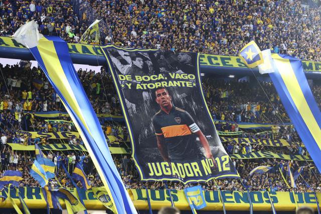 Boca Juniors' fans cheer for their team during the Argentine Professional Football League 2025 Clausura Tournament round of 16 match between Boca Juniors and Talleres de Cordoba at La Bombonera Stadium in Buenos Aires on November 23, 2025. (Photo by ALEJANDRO PAGNI / AFP)