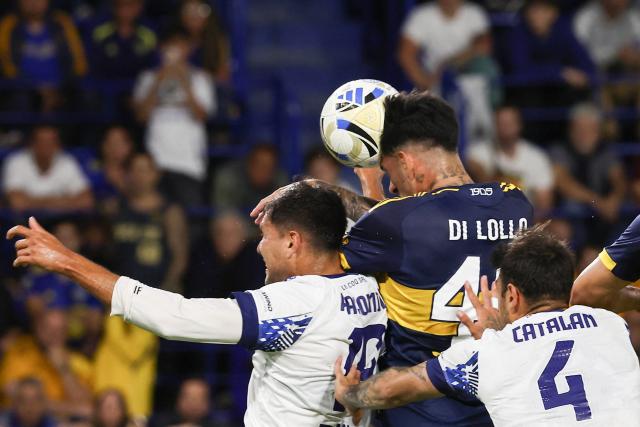 Boca Juniors' defender #40 Lautaro Di Lollo (C) heads to score a goal during the Argentine Professional Football League 2025 Clausura Tournament round of 16 match between Boca Juniors and Talleres de Cordoba at La Bombonera Stadium in Buenos Aires on November 23, 2025. (Photo by ALEJANDRO PAGNI / AFP)