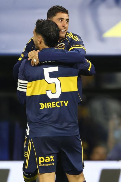 Boca Juniors’ Uruguayan forward #16 Miguel Merentiel (R) celebrates after scoring his team’s second goal with midfielder #5 Leandro Paredes during the Argentine Professional Football League 2025 Clausura Tournament round of 16 match between Boca Juniors and Talleres de Cordoba at La Bombonera Stadium in Buenos Aires on November 23, 2025. (Photo by ALEJANDRO PAGNI / AFP)