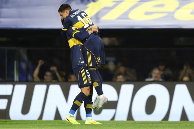 Boca Juniors’ Uruguayan forward #16 Miguel Merentiel (R) celebrates after scoring his team’s second goal with midfielder #5 Leandro Paredes during the Argentine Professional Football League 2025 Clausura Tournament round of 16 match between Boca Juniors and Talleres de Cordoba at La Bombonera Stadium in Buenos Aires on November 23, 2025. (Photo by ALEJANDRO PAGNI / AFP)
