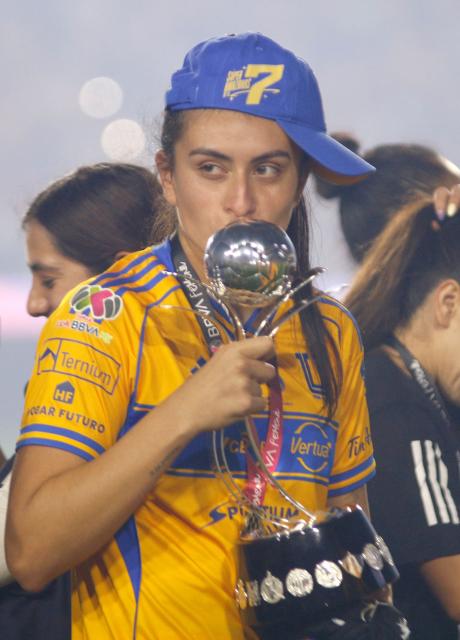 Tigres' defender #02 Natalia Corin kisses the trophy after winning the Liga MX Femenil Apertura final second leg football match between Tigres and America at the Universitario Stadium in Monterrey, Nuevo Leon state, Mexico on November 23, 2025. (Photo by Julio Cesar AGUILAR / AFP)