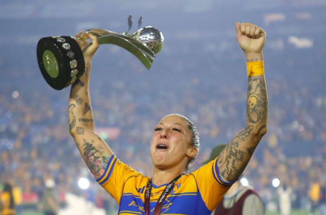 Tigres' midfielder #10 Jennifer Hermoso lifts the trophy after winning the Liga MX Femenil Apertura final second leg football match between Tigres and America at the Universitario Stadium in Monterrey, Nuevo Leon state, Mexico on November 23, 2025. (Photo by Julio Cesar AGUILAR / AFP)