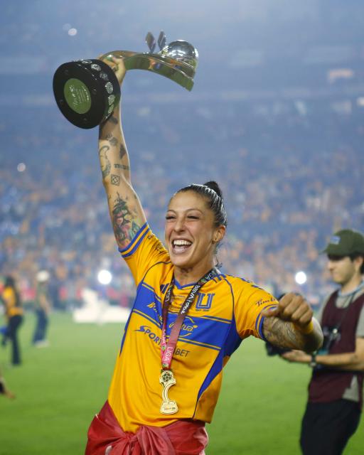 Tigres' midfielder #10 Jennifer Hermoso lifts the trophy after winning the Liga MX Femenil Apertura final second leg football match between Tigres and America at the Universitario Stadium in Monterrey, Nuevo Leon state, Mexico on November 23, 2025. (Photo by Julio Cesar AGUILAR / AFP)