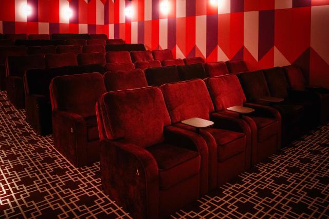 This photograph shows an interior view with movie theater seats of the Elysees Lincoln cinema in Paris on November 14, 2025. It was either reinvent themselves or close down. Faced with declining attendance, several independent Parisian cinemas have opted for innovation, opening new venues or expanding their activities, in an act of survival they describe as "militant". (Photo by Dimitar DILKOFF / AFP)
