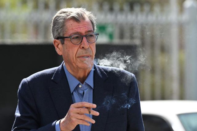 (FILES) Former Mayor of Levallois-Perret Patrick Balkany arrives at the courthouse for his trial over the dissemination of photomontages of a sexual nature of former  Levallois-Perret city councillor David-Xavier Weiss, in Nanterre, west of Paris, on April 4, 2023. The trial of the Balkany couple over damages for money laundering related to tax fraud takes place in Paris, on November 26, 2025. (Photo by Emmanuel DUNAND / AFP)