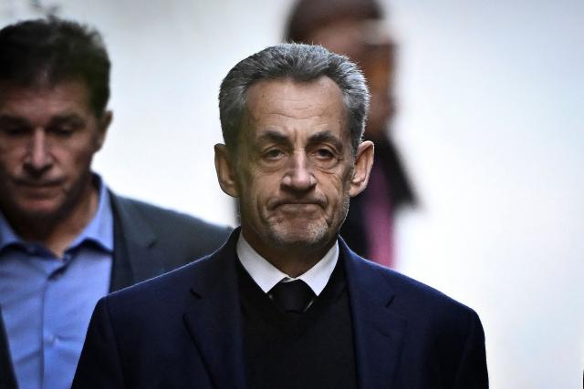 (FILES) France's former president Nicolas Sarkozy leaves his residence to present himself to La Sante Prison for incarceration on a five-year prison sentence after being convicted of criminal conspiracy over a plan for late Libyan dictator Moamer Kadhafi to fund his 2007 electoral campaign, in Paris, on October 21, 2025. The Court of Cassation delivers its ruling on Nicolas Sarkozy's appeal against his conviction in the Bygmalion case, in Paris, on November 26, 2025. (Photo by JULIEN DE ROSA / AFP)