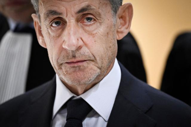 (FILES) Former French president Nicolas Sarkozy leaves after the verdict in his trial for illegal campaign financing from Libya for his successful 2007 presidential bid, at the Tribunal de Paris courthouse in Paris, on September 25, 2025. The Court of Cassation delivers its ruling on Nicolas Sarkozy's appeal against his conviction in the Bygmalion case, in Paris, on November 26, 2025. (Photo by JULIEN DE ROSA / AFP)