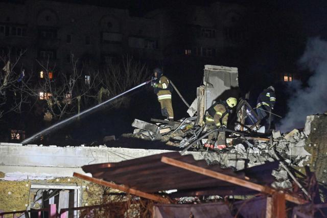 Ukrainian firefighters extinguish a fire in a house at the site of a Russian drone strike in Kharkiv late on November 23, 2025, amid the Russian invasion of Ukraine. A Russian drone strike on the major Ukrainian city of Kharkiv killed four people and wounded 17 on November 23, its mayor said. The attack came as US, Ukrainian and European officials were in Geneva to discuss a proposal to end the nearly four-year war in Ukraine, which began when Russia launched a full-scale invasion. (Photo by SERGEY BOBOK / AFP)