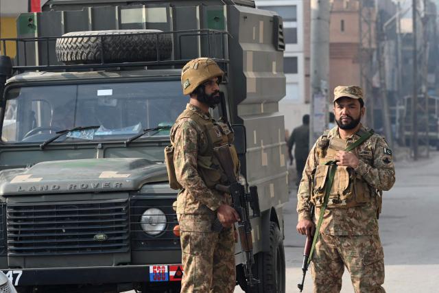 Security personnel stand guard at the site of a suicide attack outside the border force headquarters in Peshawar on November 24, 2025. A suicide bombing killed three Pakistani paramilitary personnel Monday at the border force headquarters in Peshawar city, police told AFP. (Photo by Abdul MAJEED / AFP)