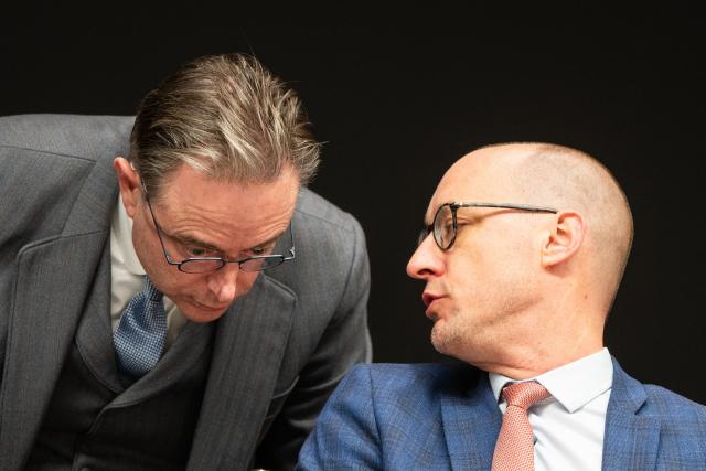 Belgium's Prime Minister Bart De Wever (L) speaks with Belgium's Vice Prime Minister and Minister of Budget Vincent Van Peteghem during a press conference to announce an agreement on the budget following a meeting with Ministers of Belgium's Federal Government, on November 24, 2025 in Brussels on the first day of a 72 hours strike in the country. Trains cancelled, flights cancelled, nurseries closed: Belgium is preparing on November 24 for three days of strikes against the reforms planned by the De Wever government. (Photo by EMILE WINDAL / Belga / AFP) / Belgium OUT