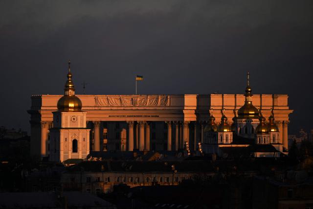 A photograph taken on November 24, 2025 shows building of the Ukrainian Ministry of Foreign Affairs and St. Michael's Golden-Domed Monastery illuminated by a beam of sunlight during sunrise in Kyiv, amid the Russian invasion of Ukraine. (Photo by Sergei GAPON / AFP)