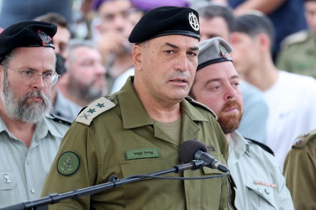 (FILES) Israel's military chief Lieutenant General Eyal Zamir speaks during the funeral of Lieutenant Hadar Goldin who was killed during the six-week 2014 war in Gaza, in a military cemetery in Kfar Saba on November 11, 2025. Israel's military chief Lieutenant General Eyal Zamir announced the dismissal of several senior officers over their failure to prevent the October 2023 attacks by Hamas, late on November 23, 2025. The war was sparked by Hamas's October 7, 2023 attack on Israel, which resulted in the deaths of 1,221 people. Israel's retaliatory assault on Gaza has killed at least 69,733 people, according to figures from the health ministry on November 22, 2025, that the UN considers reliable. (Photo by Abir SULTAN / POOL / AFP)