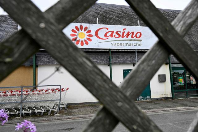 (FILES) This photograph shows the logo of Casino in the entrance of a Casino shop in Ploubalay, western France on July 5, 2023. On November 24, 2025, the Casino Group announced that it would be bringing together its creditors to begin negotiations on a new debt restructuring, the second in less than three years, with its main shareholder, Daniel Kretinsky, saying he was prepared to contribute Ђ300 million. (Photo by Damien MEYER / AFP)