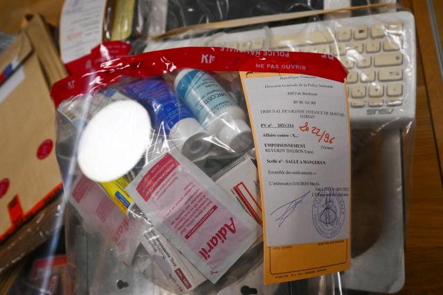 A photograph taken on November 24, 2025 shows evidences displayed in the courtroom of the Assize Court of the Landes department, in Mont-de-Marsan, in southwestern France, prior to the start of the trial of Maylis Daubon, charged with poisoning her two daughters, one of whom died. The trial of Maylis Daubon, 53, accused of poisoning her two daughters, one of whom died, by drugging them, then attempting to have their father murdered from prison, is set to open on November 24. Maylis Daubon has maintained since her indictment and imprisonment in January 2022 that her eldest daughter, who died at the age of 18, committed suicide (Photo by Gaizka IROZ / AFP)