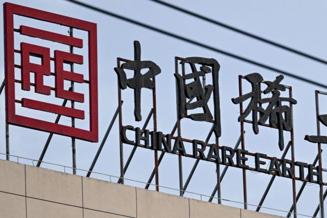 The logo and signage of the China Rare Earth Group is seen at its processing plant in Longnan county, Ganzhou, in eastern China's Jiangxi province on November 20, 2025. (Photo by Hector RETAMAL / AFP)