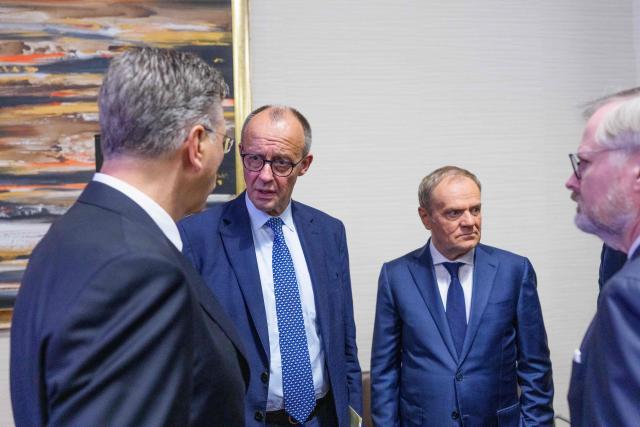 (L-R) Croatia's Prime Minister Andrej Plenkovic, Germany's Chancellor Friedrich Merz, Poland's Prime Minister Donald Tusk and Czech Republic's Prime Minister Petr Fiala talk as they attend a EU meeting at the European Union (EU) - African Union (AU) summit in Luanda, Angola, on November 24, 2025. European and African leaders gather in Angola for a summit to deepen economic and security ties, with emergency talks on Ukraine also on the cards. (Photo by Michael Kappeler / POOL / AFP)