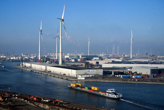 A barge transporting containers navigates along the Port of Antwerp-Bruges, in Antwerp, on November 21, 2025. (Photo by Nicolas TUCAT / AFP)