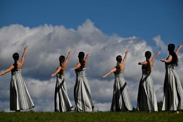Actresses perform during a rehearsal of the lighting of the Olympic flame for the Milano-Cortina 2026 Winter Olympic Games, in the ancient Temple of Hera at the archaeological site of Olympia, birthplace of the ancient Olympics in southern Greece, on November 24, 2025. (Photo by Aris MESSINIS / AFP)