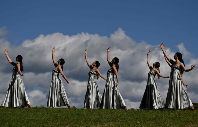Actresses perform during a rehearsal of the lighting of the Olympic flame for the Milano-Cortina 2026 Winter Olympic Games, in the ancient Temple of Hera at the archaeological site of Olympia, birthplace of the ancient Olympics in southern Greece, on November 24, 2025. (Photo by Aris MESSINIS / AFP)