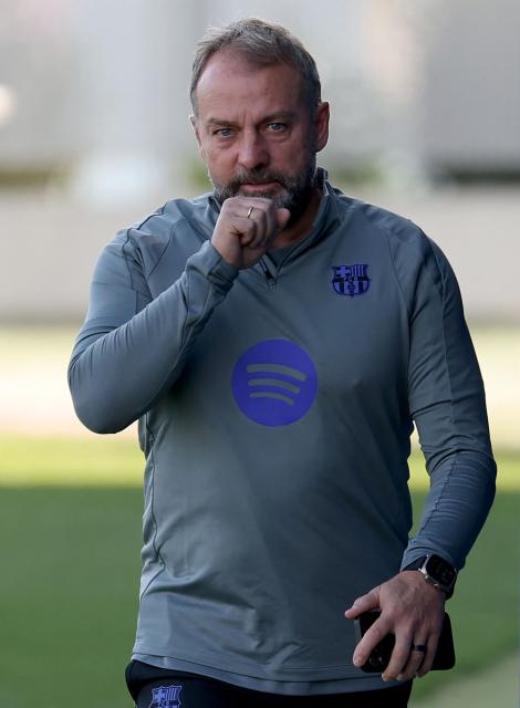 Barcelona's German coach Hans-Dieter Flick arrives to a training session on the eve of their UEFA Champions League, league phase day 5 football match against Chelsea at the Joan Gamper training ground in Sant Joan Despi, near Barcelona, on November 24, 2025. (Photo by Lluis GENE / AFP)