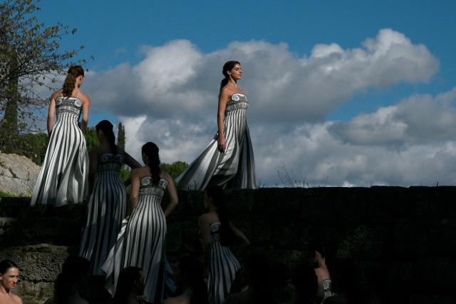 Actresses perform during a rehearsal of the lighting of the Olympic flame for the Milano-Cortina 2026 Winter Olympic Games, in the ancient Temple of Hera at the archaeological site of Olympia, birthplace of the ancient Olympics in southern Greece, on November 24, 2025. (Photo by Aris MESSINIS / AFP)