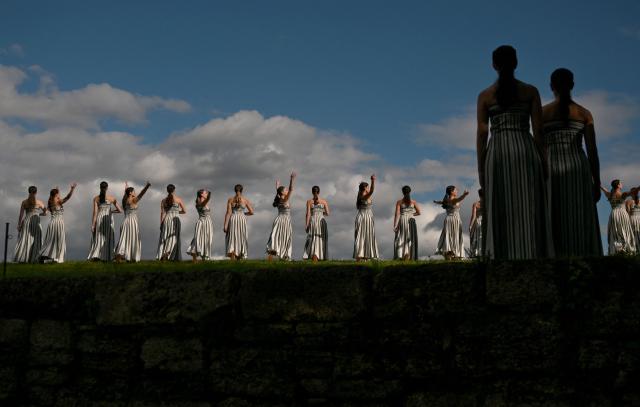 Actresses perform during a rehearsal of the lighting of the Olympic flame for the Milano-Cortina 2026 Winter Olympic Games, in the ancient Temple of Hera at the archaeological site of Olympia, birthplace of the ancient Olympics in southern Greece, on November 24, 2025. (Photo by Aris MESSINIS / AFP)