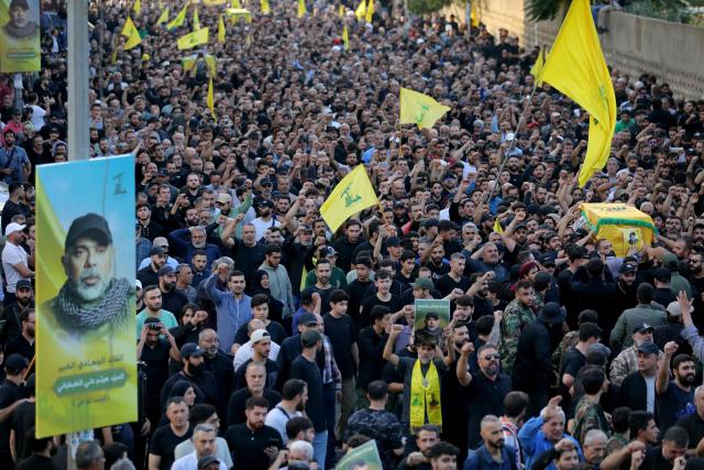 Mourners carry the coffins of top Hezbollah chief Haytham Ali Tabatabai and others killed in an Israeli strike a day earlier, during their funeral in Beirut’s southern suburbs on November 24, 2025. Hezbollah held the funeral on November 24 for its top military chief and other members of the militant group a day after Israel killed them in a strike on Beirut's southern suburbs. (Photo by Ibrahim AMRO / AFP)