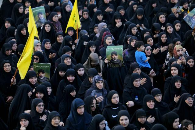 Mourners carry pictures of slain Hezbollah chief Haytham Ali Tabatabai, who was killed in an Israeli strike a day earlier, during his funeral in Beirut’s southern suburbs on November 24, 2025. Hezbollah held the funeral on November 24 for its top military chief and other members of the militant group a day after Israel killed them in a strike on Beirut's southern suburbs. (Photo by Ibrahim AMRO / AFP)