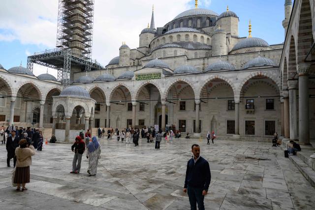 Tourists visit Sultan Ahmed Mosque, also known as the Blue Mosque, ahead of the visit of Pope Leo XIV to Turkey, in Istanbul on November 24, 2025. (Photo by Yasin AKGUL / AFP)