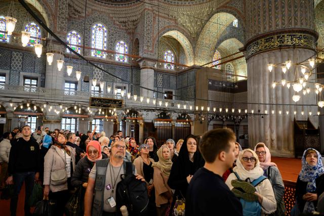Tourists visit Sultan Ahmed Mosque, also known as the Blue Mosque, ahead of the visit of Pope Leo XIV to Turkey, in Istanbul on November 24, 2025. (Photo by Yasin AKGUL / AFP)
