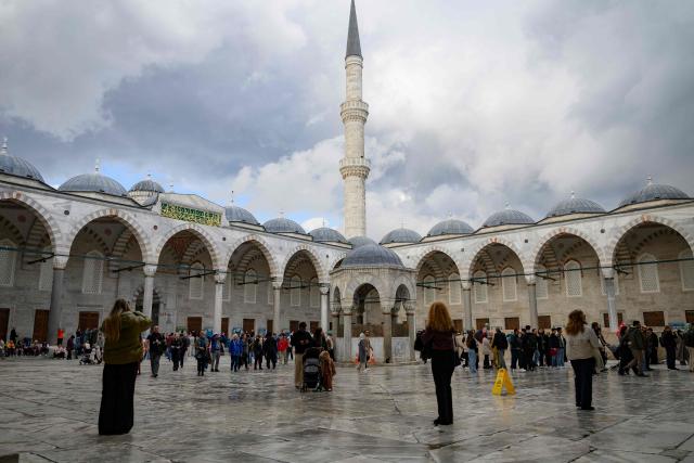 Tourists visit Sultan Ahmed Mosque, also known as the Blue Mosque, ahead of the visit of Pope Leo XIV to Turkey, in Istanbul on November 24, 2025. (Photo by Yasin AKGUL / AFP)