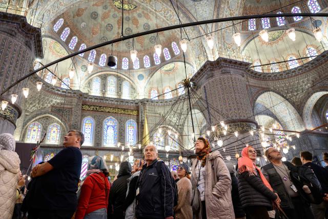 Tourists visit Sultan Ahmed Mosque, also known as the Blue Mosque, ahead of the visit of Pope Leo XIV to Turkey, in Istanbul on November 24, 2025. (Photo by Yasin AKGUL / AFP)