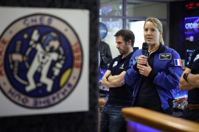 Astronaut Sophie Adenot (R) speaks during a press conference regarding her departure for the International Space Station (ISS) in 2026, at the CNES, Centre national d'études spatiales (National Center for Space Studies) in Toulouse, southwestern France on November 24, 2025. (Photo by Valentine CHAPUIS / AFP)