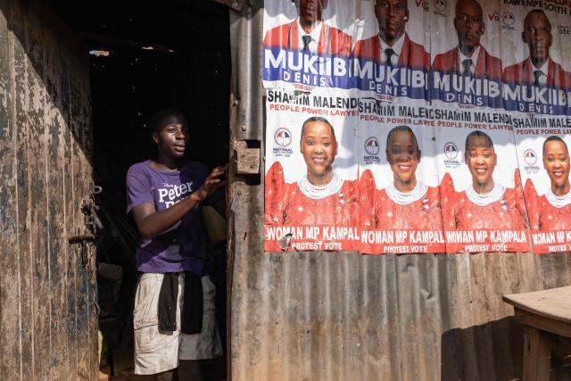 A young resident takes cover as supporters of National Unity Platform (NPU) presidential candidate and opposition leader Robert Kyagulanyi, also known as Bobi Wine, flee from tear gas fired by Ugandan police officers during a dispersal operation following his presidential campaign rally in Kampala, on November 24, 2025. Bobi Wine, the main challenger to President Yoweri Museveni's 40-year rule in Uganda, drew vast crowds as he brought his campaign to the capital Kampala on November 24, 2025 ahead of January's election.
Wine, whose real name is Robert Kyagulanyi, is a 43-year-old singer turned politician who has become hugely popular among Ugandan young people but faces a deeply entrenched political machine led by the 81-year-old Museveni. (Photo by Badru Katumba / AFP)