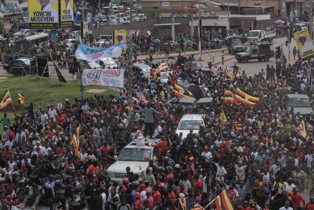 National Unity Platform (NPU) presidential candidate and opposition leader Robert Kyagulanyi, also known as Bobi Wine, addresses supporters from the roof of a car as they follow his convoy before a campaign rally in Kampala on November 24, 2025. Bobi Wine, the main challenger to President Yoweri Museveni's 40-year rule in Uganda, drew vast crowds as he brought his campaign to the capital Kampala on November 24, 2025 ahead of January's election.
Wine, whose real name is Robert Kyagulanyi, is a 43-year-old singer turned politician who has become hugely popular among Ugandan young people but faces a deeply entrenched political machine led by the 81-year-old Museveni. (Photo by BADRU KATUMBA / AFP)
