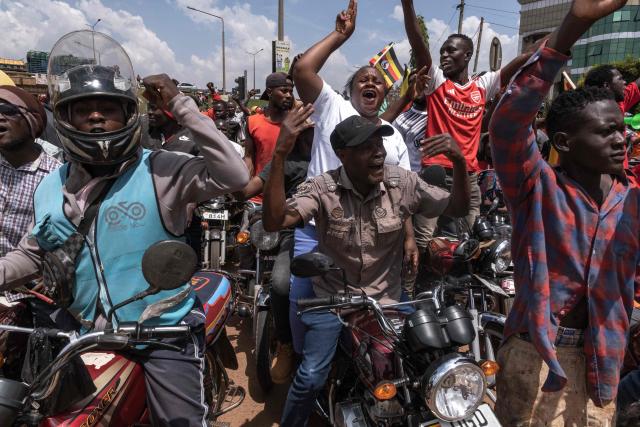 Supporters of the National Unity Platform (NPU) chant slogans as they follow the convoy of presidential candidate and opposition leader Robert Kyagulanyi, also known as Bobi Wine (unseen), ahead of a campaign rally in Kampala, on November 24, 2025. Bobi Wine, the main challenger to President Yoweri Museveni's 40-year rule in Uganda, drew vast crowds as he brought his campaign to the capital Kampala on November 24, 2025 ahead of January's election.
Wine, whose real name is Robert Kyagulanyi, is a 43-year-old singer turned politician who has become hugely popular among Ugandan young people but faces a deeply entrenched political machine led by the 81-year-old Museveni. (Photo by BADRU KATUMBA / AFP)