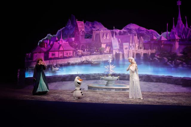 Performers in the characters of Anna (L), Olaf (C), and Elsa (R), talk about the new World of Frozen, inside the Disney Adventure World (former Walt Disney Studios) in Disneyland Paris, in Marne-la-Vallee, east of Paris on November 24, 2025. The Disney adventure World will open on March 29, 2026. (Photo by GEOFFROY VAN DER HASSELT / AFP)