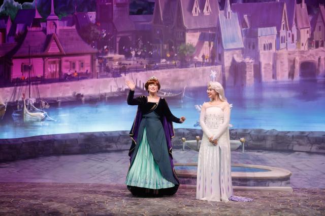 Performers in the characters of Anna (L) and Elsa (R) talk about the new World of Frozen, inside the Disney Adventure World (former Walt Disney Studios) in Disneyland Paris, in Marne-la-Vallee, east of Paris on November 24, 2025. The Disney adventure World will open on March 29, 2026. (Photo by GEOFFROY VAN DER HASSELT / AFP)