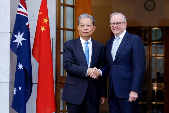 Australia’s Prime Minister Anthony Albanese (R), shakes hands with Zhao Leji, Chairman of the Standing Committee of China’s National People’s Congress (NPC), at Parliament House in Canberra on November 25, 2025. Zhao is on an official four-day visit to Australia. (Photo by HILARY WARDAUGH / AFP)