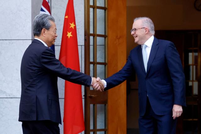 Australia’s Prime Minister Anthony Albanese (R), shakes hands with Zhao Leji, Chairman of the Standing Committee of China’s National People’s Congress (NPC), at Parliament House in Canberra on November 25, 2025. Zhao is on an official four-day visit to Australia. (Photo by HILARY WARDAUGH / AFP)