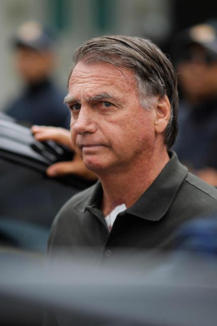 (FILES) Former Brazilian President (2019-2022) Jair Bolsonaro leaves the DF Star hospital in Brasilia on September 14, 2025, after undergoing a series of medical examinations, as he remains under house arrest. Brazil's Supreme Court on Monday voted to uphold the imprisonment of former president Jair Bolsonaro, who was detained over the weekend for tampering with his ankle monitor using a soldering iron. (Photo by Sergio Lima / AFP)