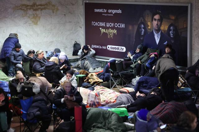 People take shelter at a metro station during Russian air attacks in Kyiv on November 25, 2025, amid the Russian invasion of Ukraine. Powerful explosions rocked Ukraine's capital Kyiv, an AFP journalist heard, as the air force issued a countrywide missile warning early November 25, 2025. (Photo by Yan Dobronosov / AFP)