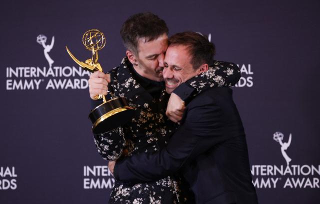 Spanish director Javier Giner (L) kisses Spanish actor Oriol Pla in the press room after he won the Best Performance by an Actor award for "I, Addict" during the 53rd International Emmy Awards Gala at the New York Hilton Midtown on November 24, 2025 in New York City. (Photo by Leonardo MUNOZ / AFP)