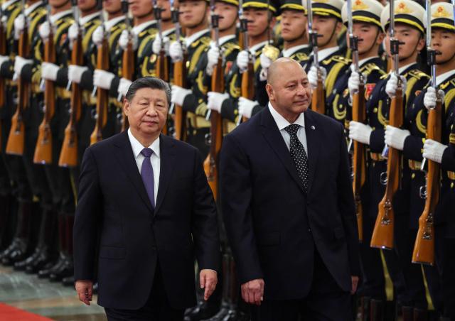 Tonga's King Tupou VI and China’s President Xi Jinping attend a welcoming ceremony at the Great Hall of the People in Beijing on November 25, 2025. (Photo by Maxim Shemetov / POOL / AFP)