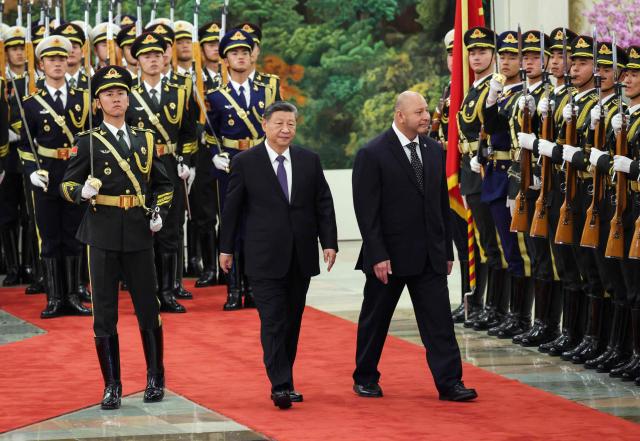 Tonga's King Tupou VI and China’s President Xi Jinping attend a welcoming ceremony at the Great Hall of the People in Beijing on November 25, 2025. (Photo by Maxim Shemetov / POOL / AFP)