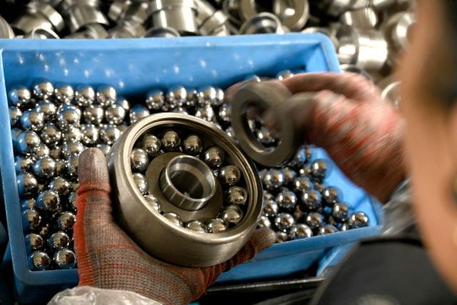An employee works in a ball bearing factory in Handan, in northern China's Hebei province on November 24, 2025. (Photo by AFP) / China OUT