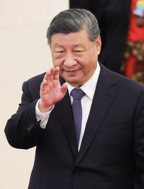 China’s President Xi Jinping waves as he attends a welcoming ceremony for Tonga's King Tupou VI (not pictured) at the Great Hall of the People in Beijing on November 25, 2025. (Photo by Maxim Shemetov / POOL / AFP)