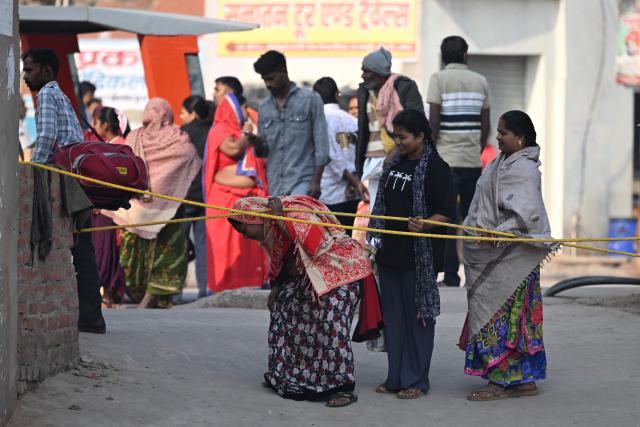 Hindu devotees arrive near Ram Temple in Ayodhya on November 25, 2025, ahead of Indian Prime Minister Narendra Modi’s visit. (Photo by Sajjad HUSSAIN / AFP)
